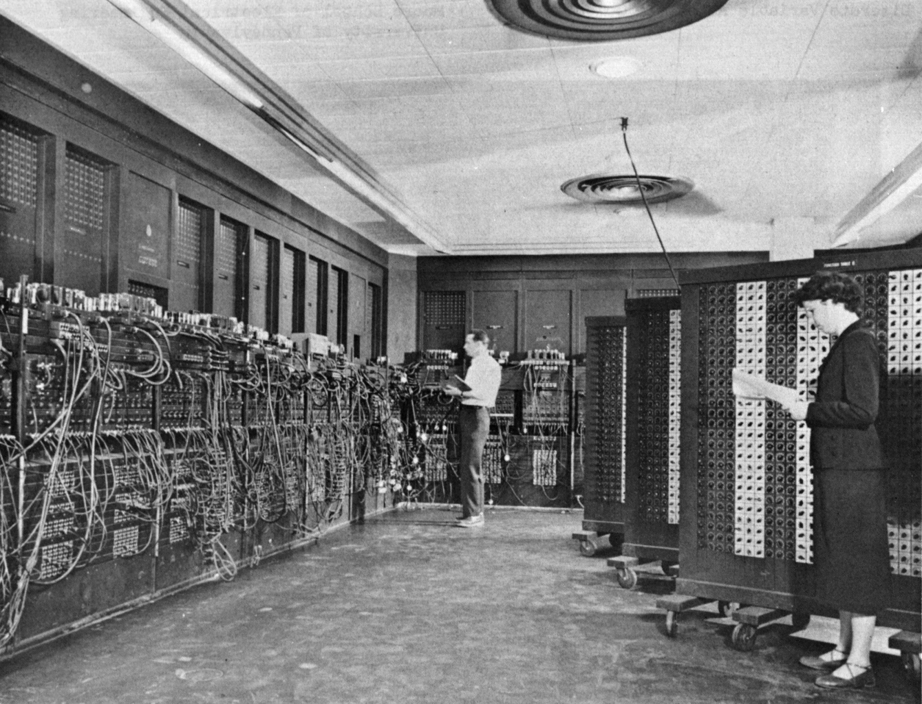 Historical ENIAC computing room with operators and extensive cables